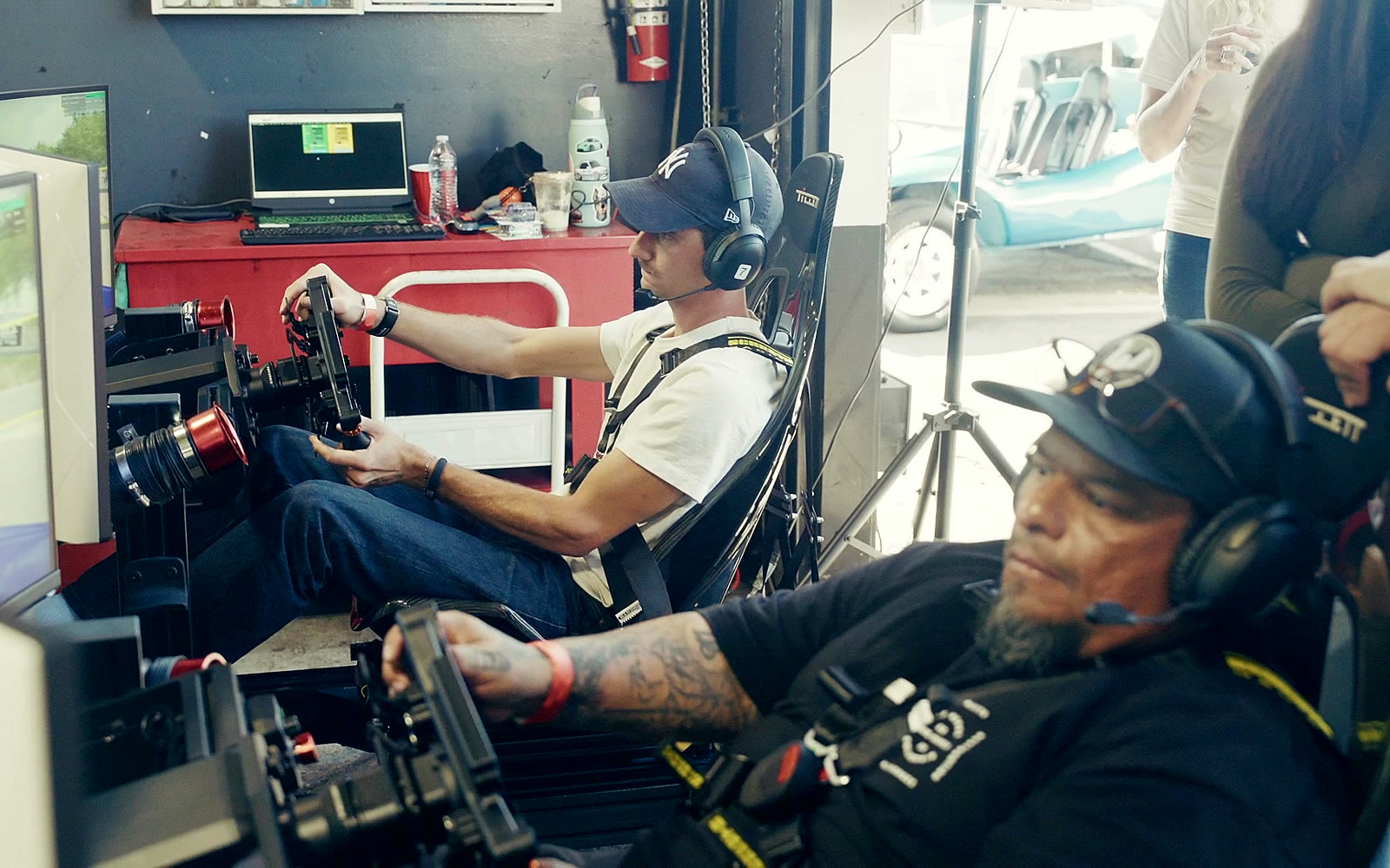 Guests racing on Trackside simulators at the Pit Stop at Performance Plus fundraiser for DSF Werks