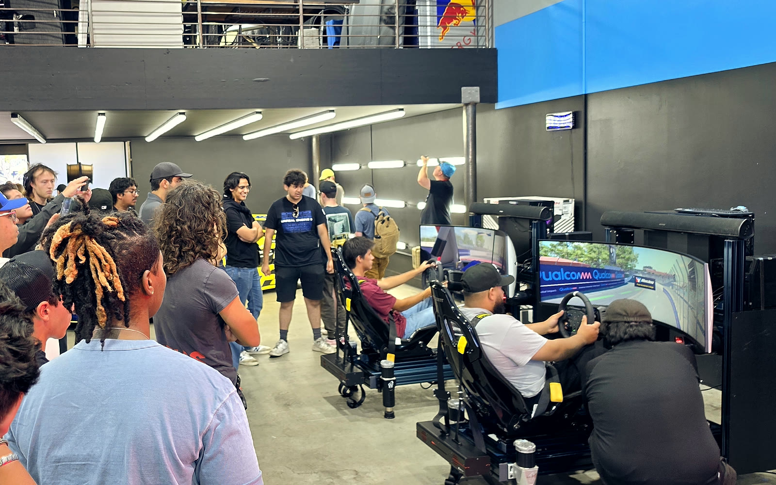 Fans racing head-to-head on Trackside full-motion simulators at the NASCAR San Diego fan activation