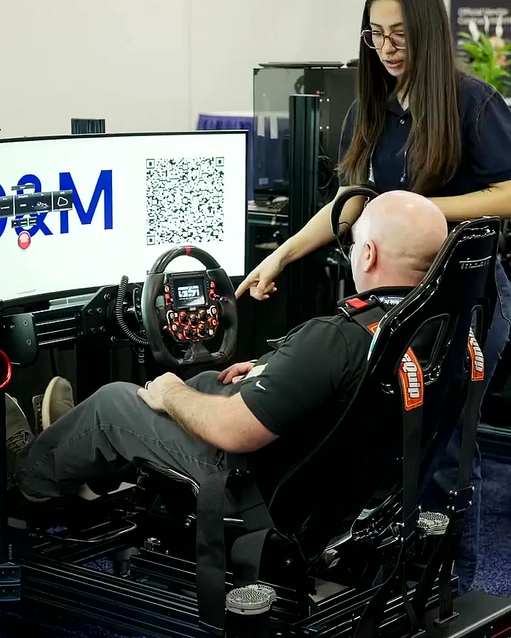Trackside race director helping a driver get set at the MD&M West booth